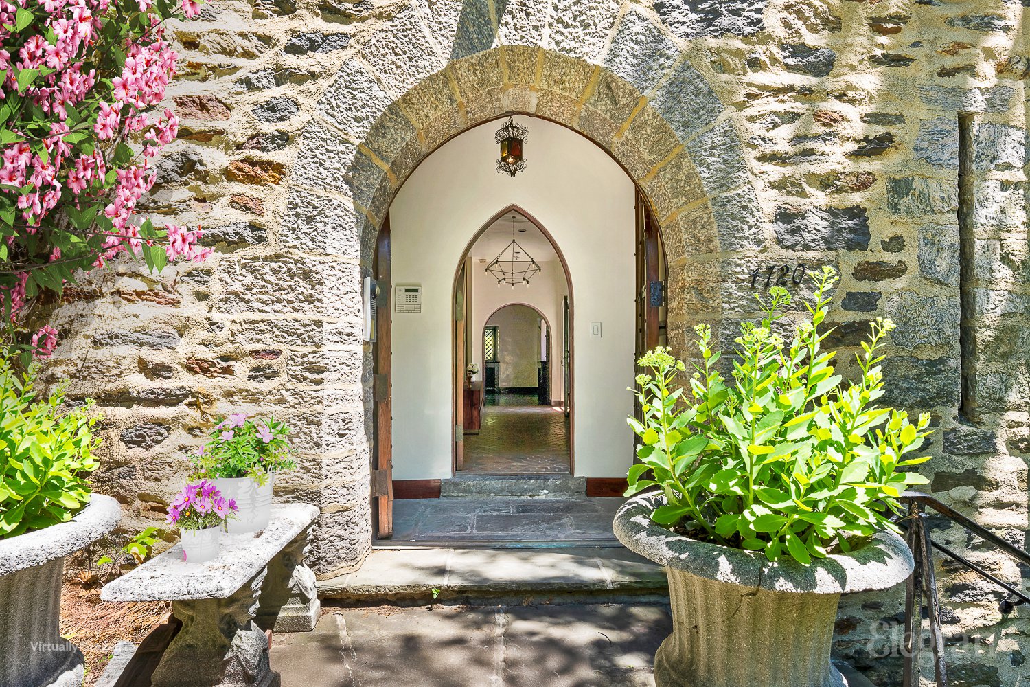 a view of a stone house with a potted plant