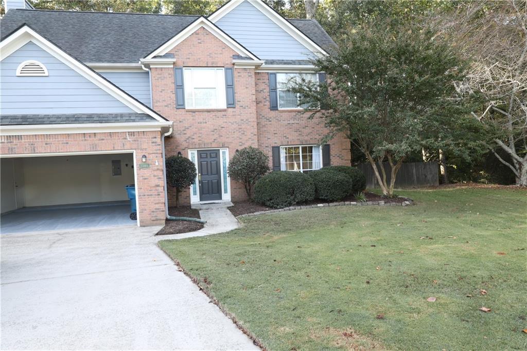 a front view of a house with a yard