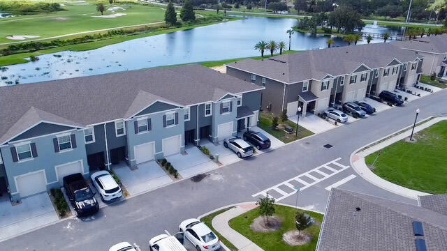 an aerial view of a house with garden space and street view