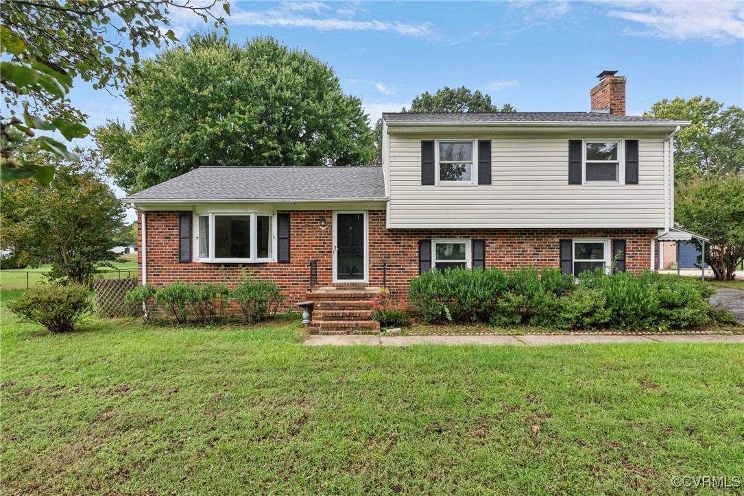 Tri-level home with a front lawn