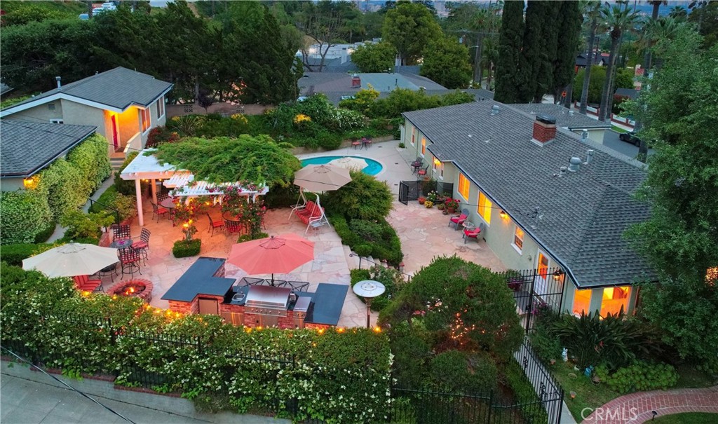 an aerial view of house with yard swimming pool and outdoor seating