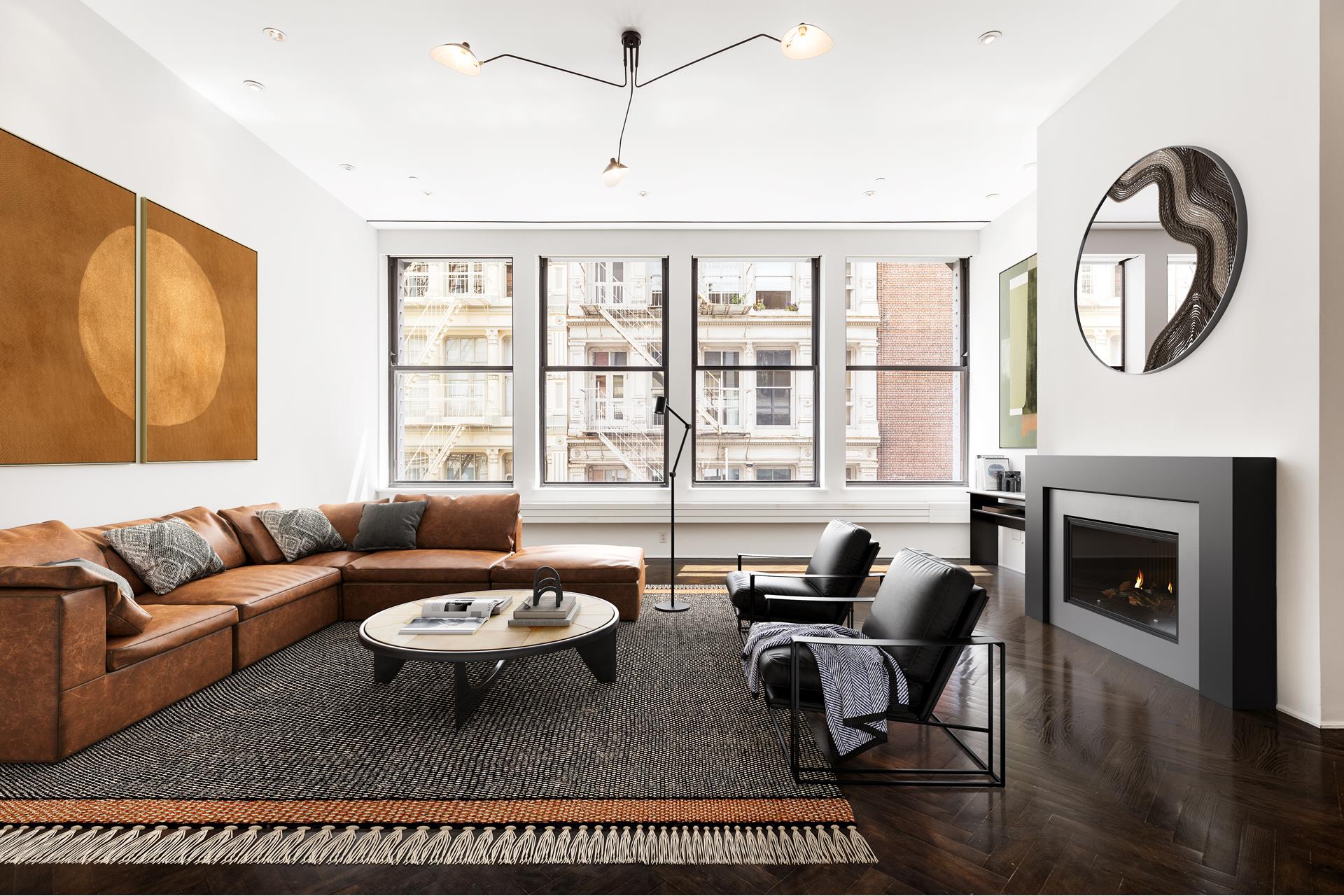 a living room with furniture a fireplace and a large window