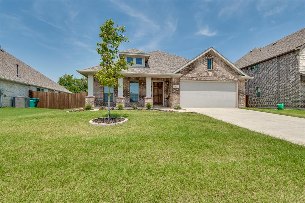 a front view of a house with yard and green space