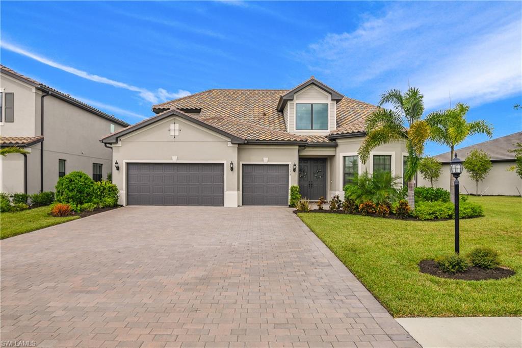 a front view of a house with a yard and garage