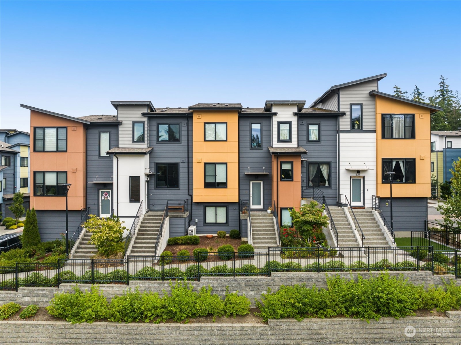 a front view of a residential apartment building with a yard