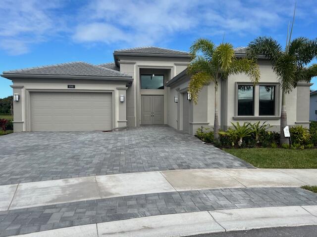 a front view of a house with a yard and garage