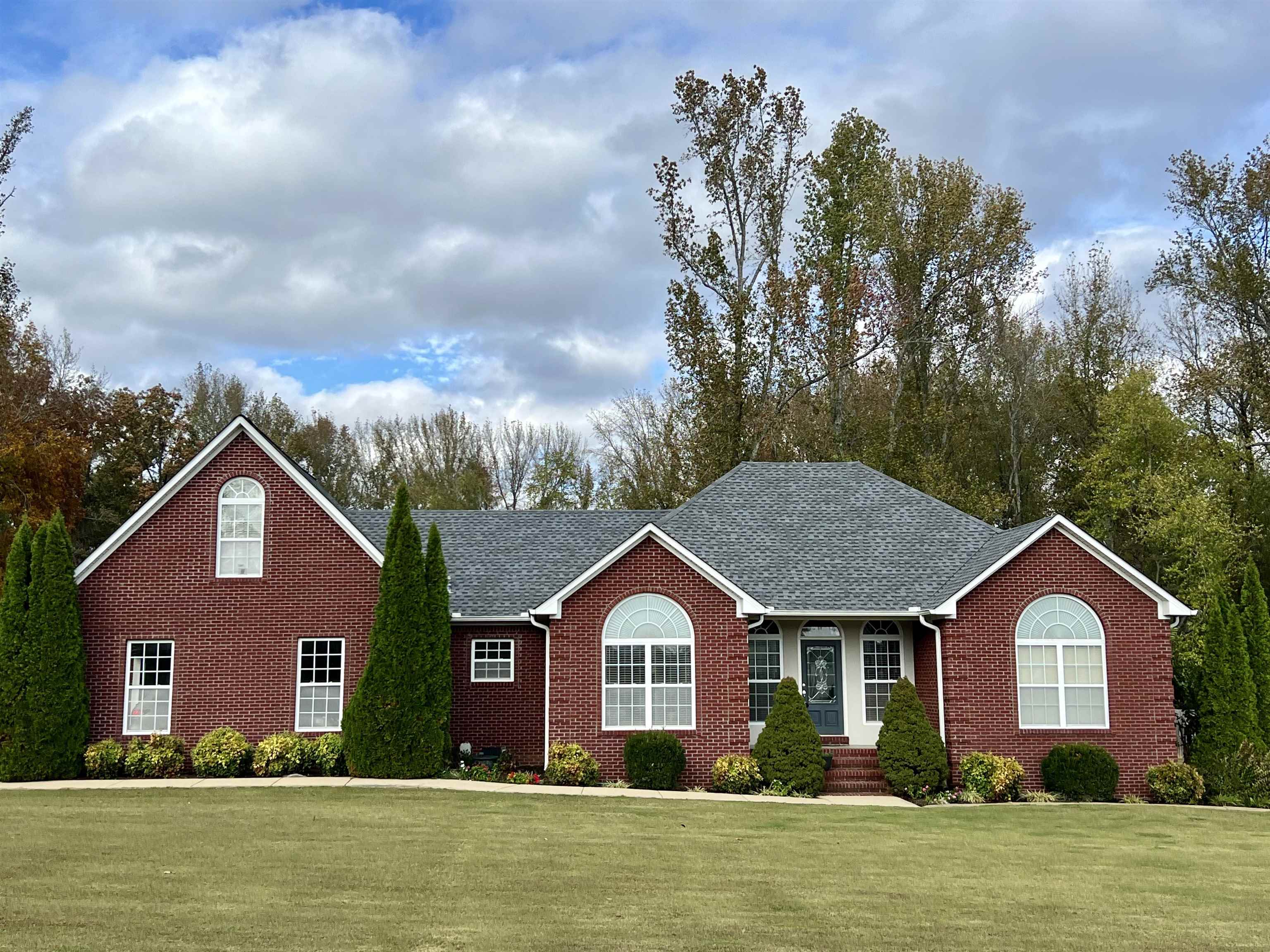 a front view of a house with a garden