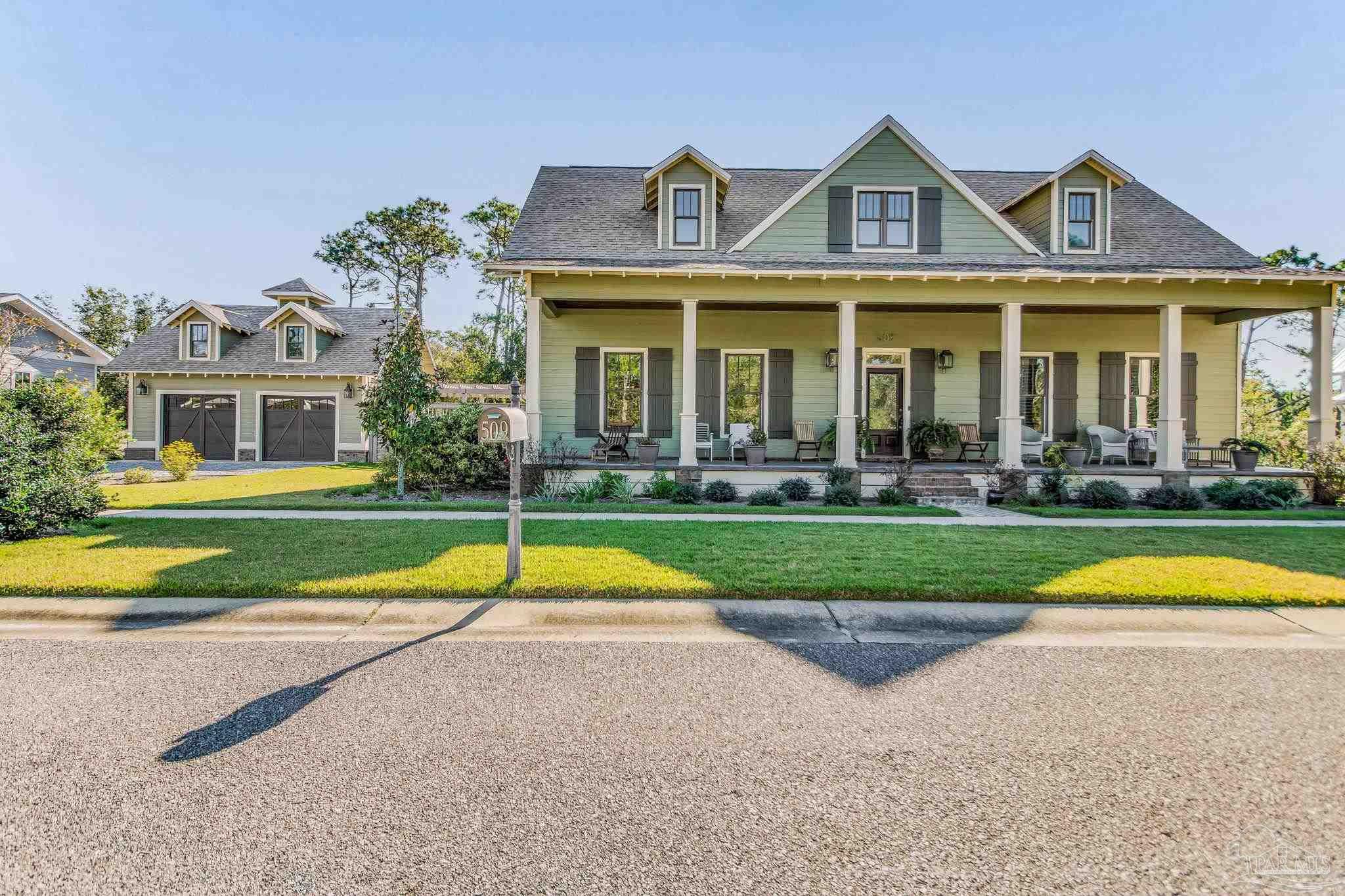 a front view of a house with swimming pool and yard