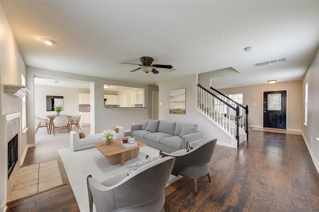 a living room with fireplace furniture and a wooden floor