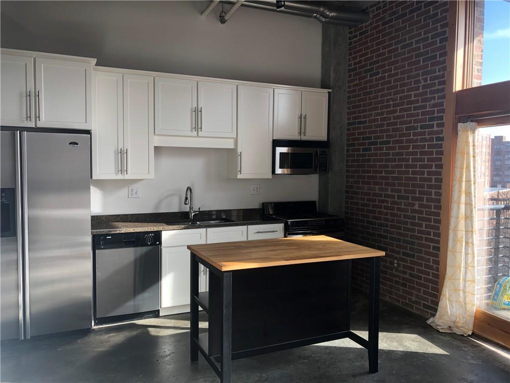 a kitchen with a sink cabinets and appliances