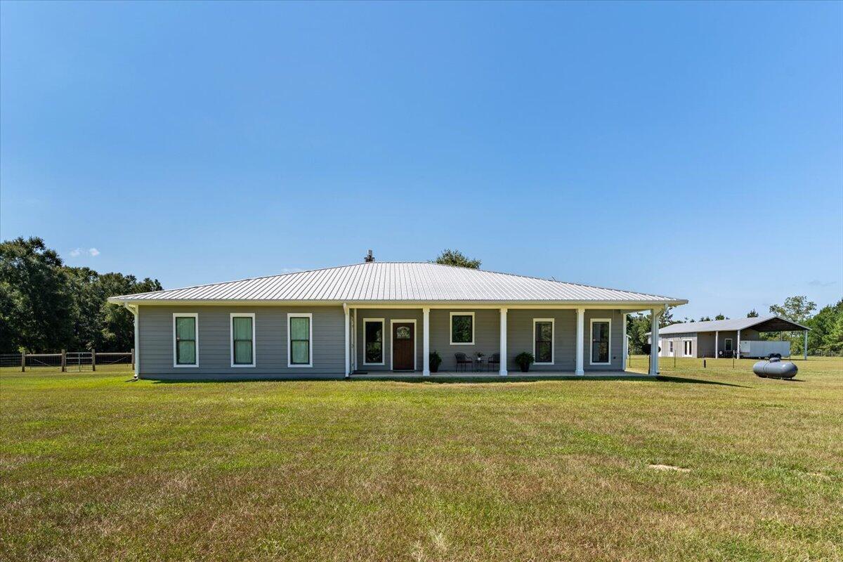 a front view of a house with a garden