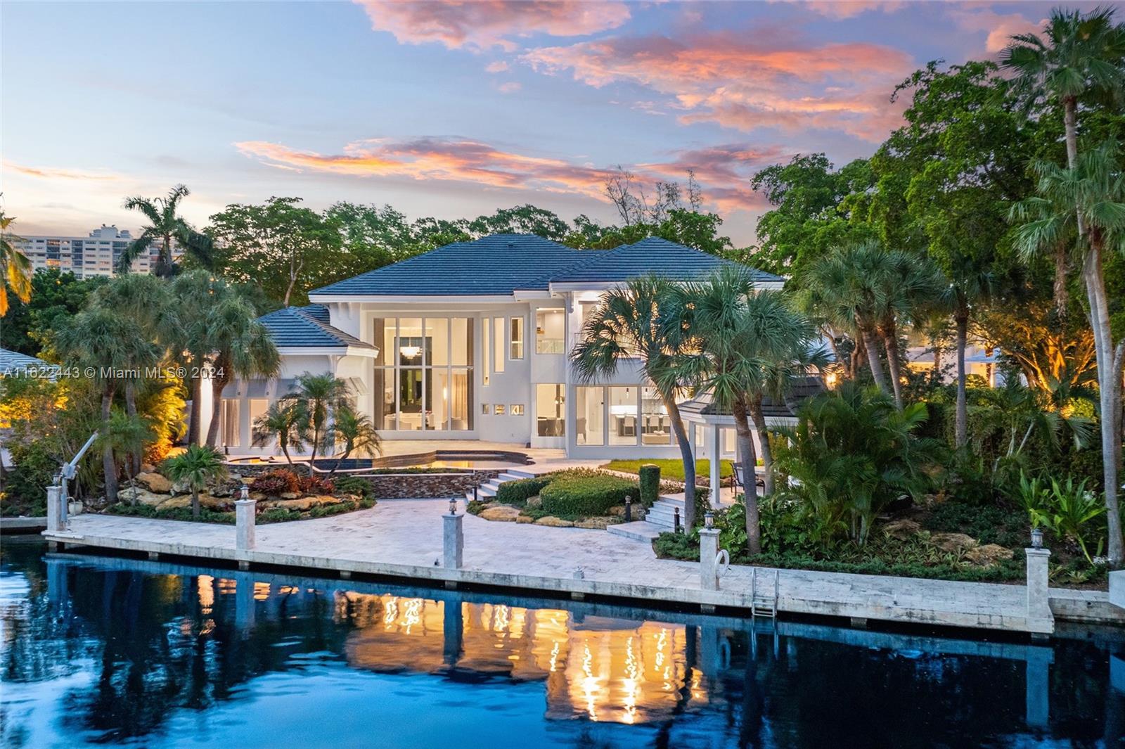 a view of a house with pool and chairs