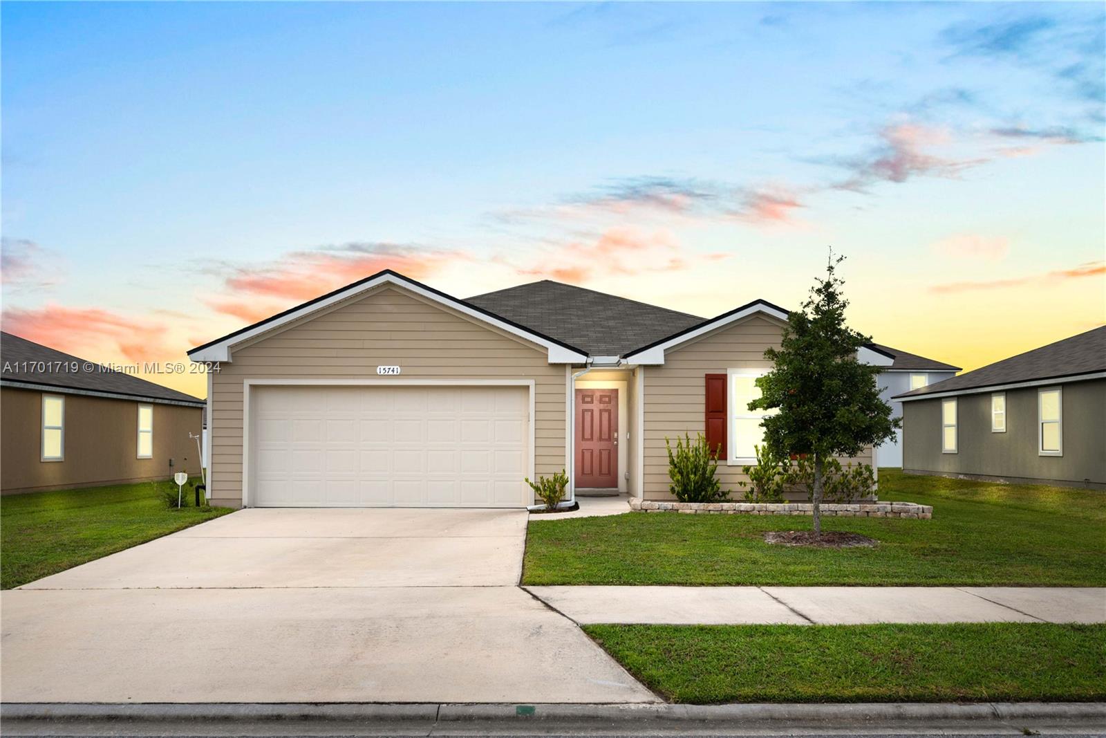 a front view of a house with a yard and garage