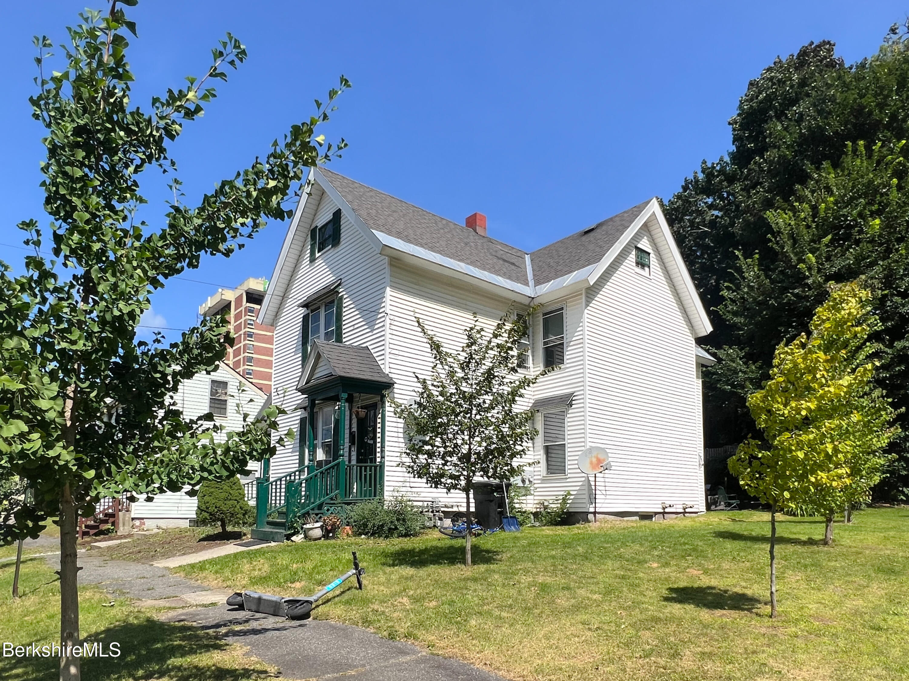 a front view of a house with a garden