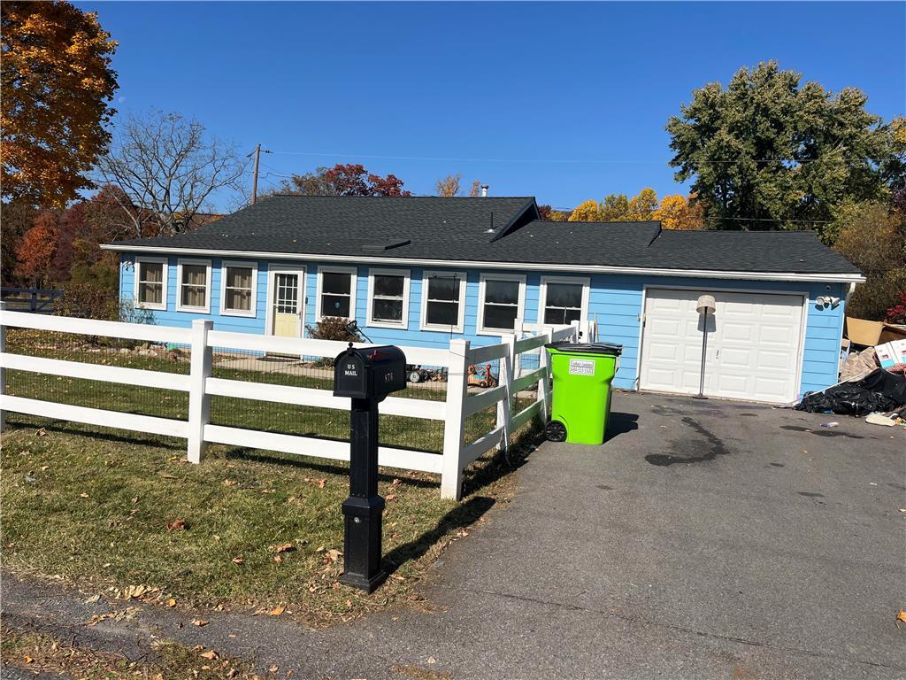 a view of a house with a backyard and a tree