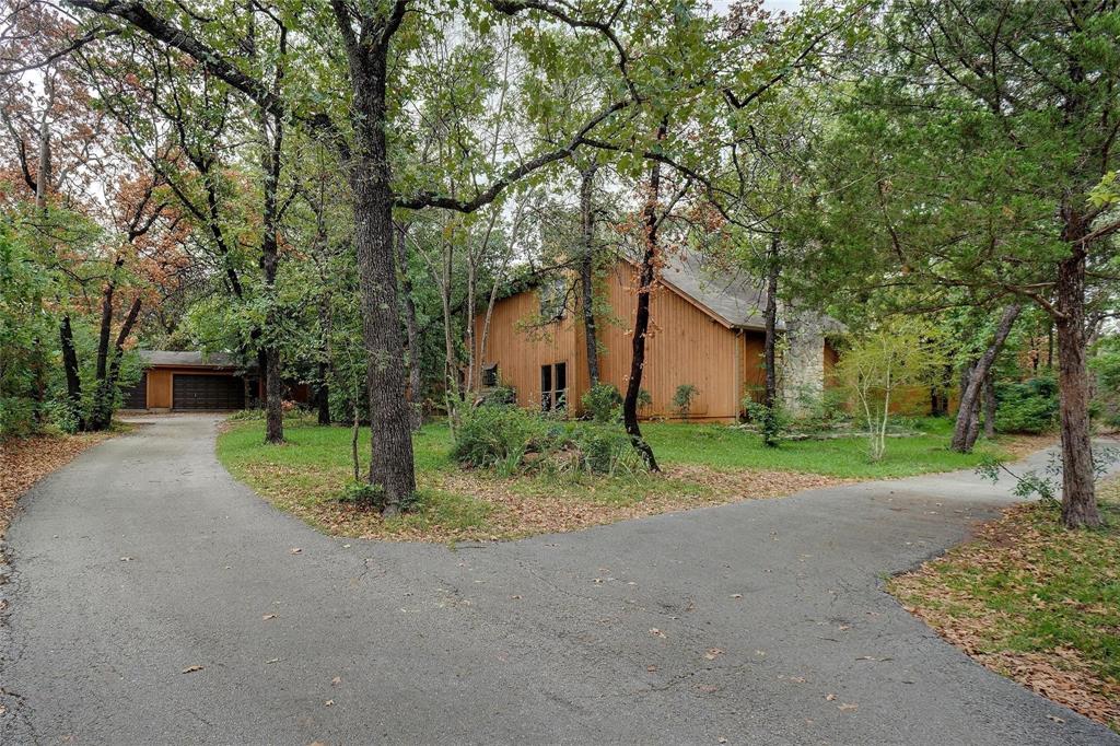 a view of a house with a tree in front of it