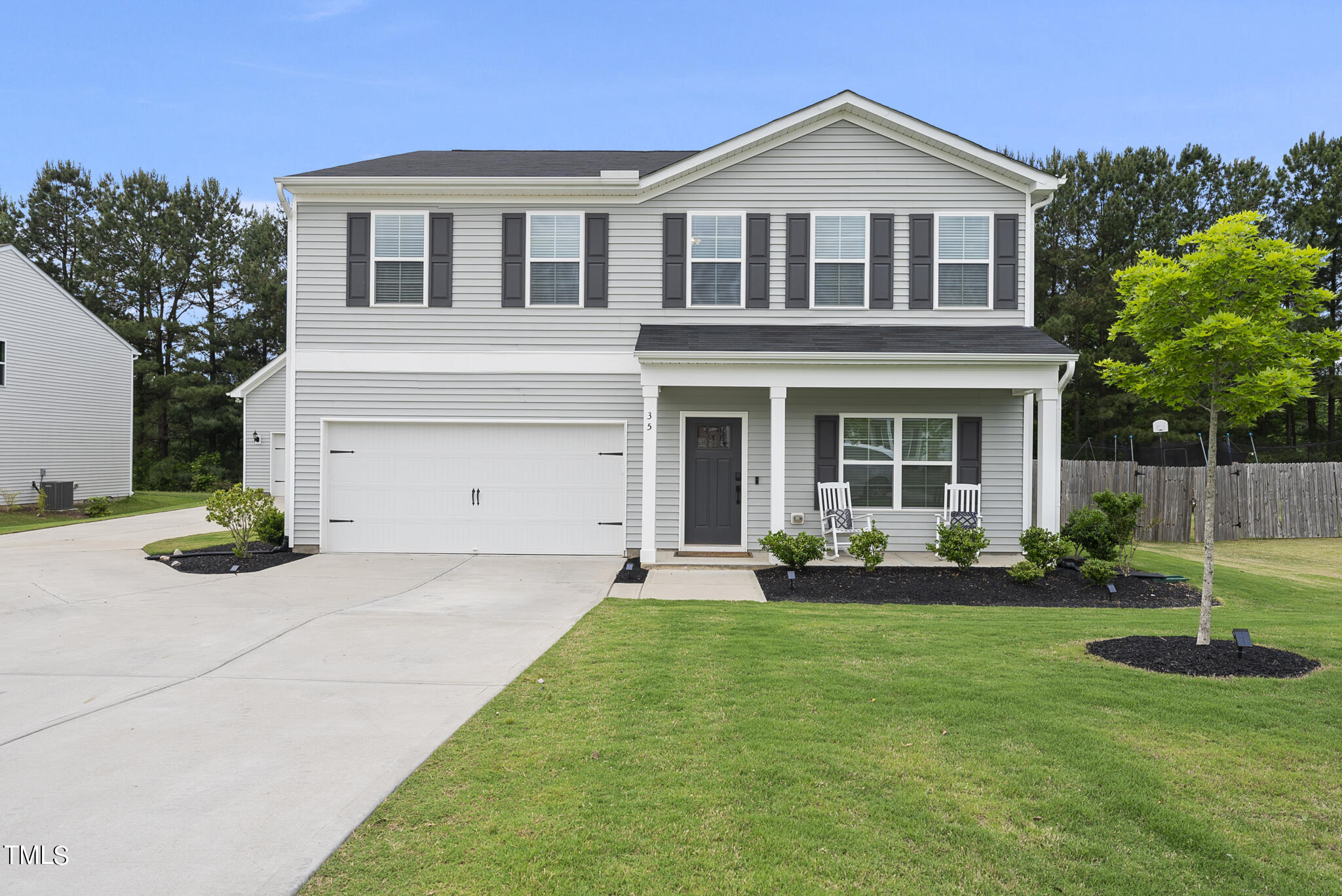 a front view of a house with a yard and porch