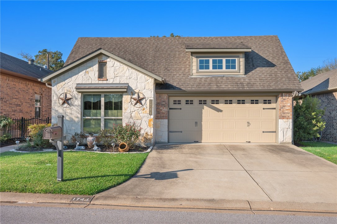 View of front of home featuring a garage and a fro