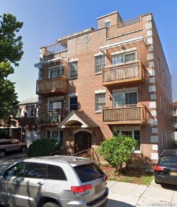 a front view of a residential apartment building with a yard