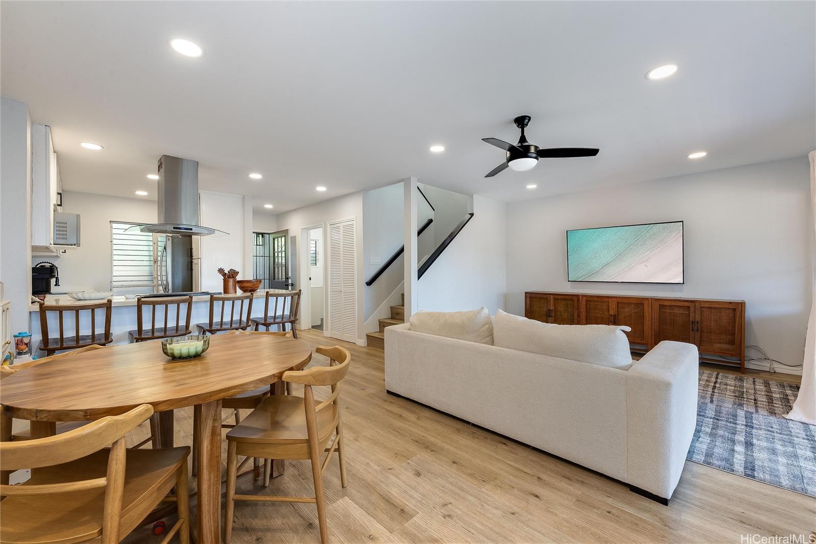 a living room with furniture and a wooden floor