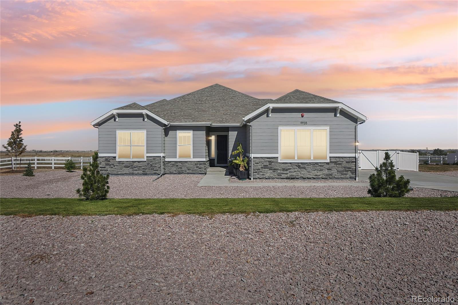 a front view of a house with a yard and a garage