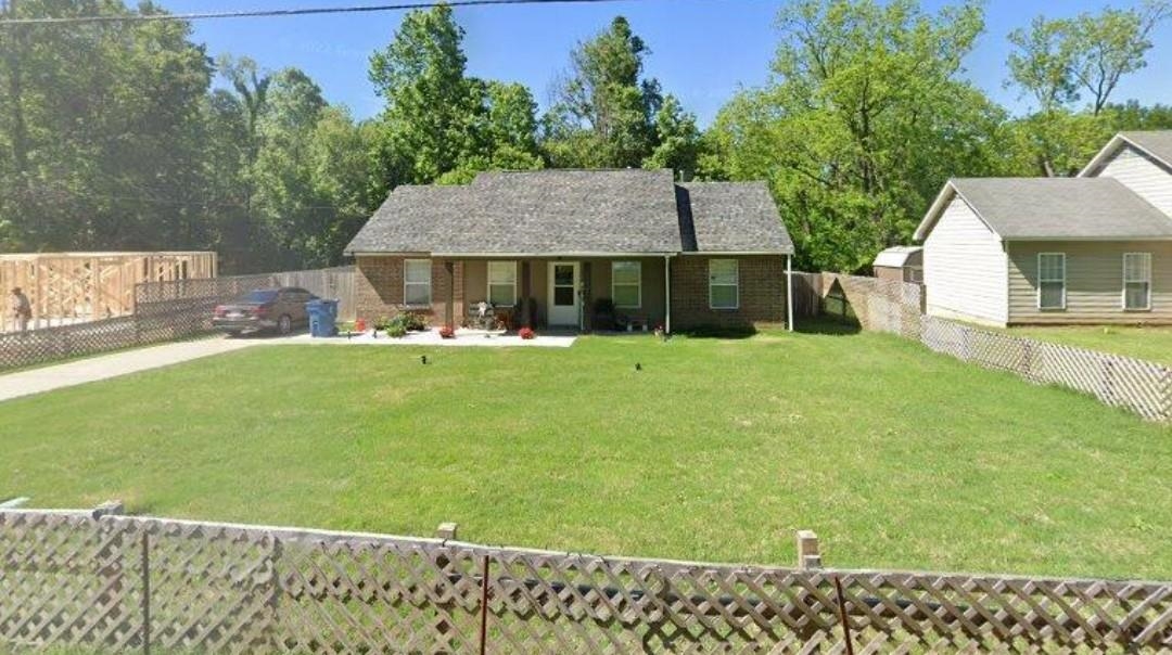 a view of a house with a yard and sitting area