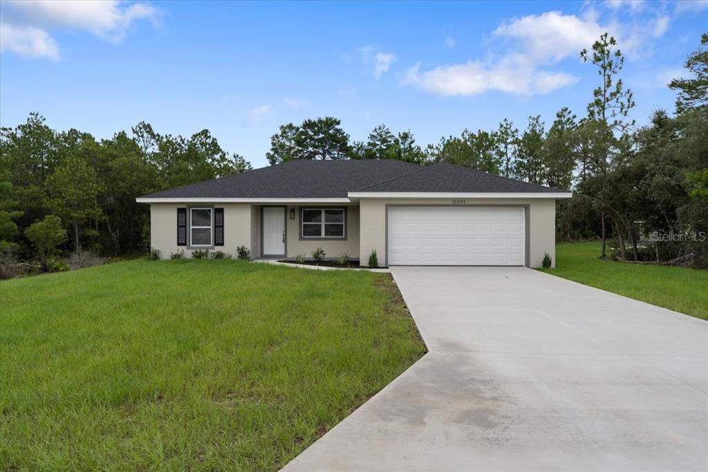 a front view of house with yard and green space