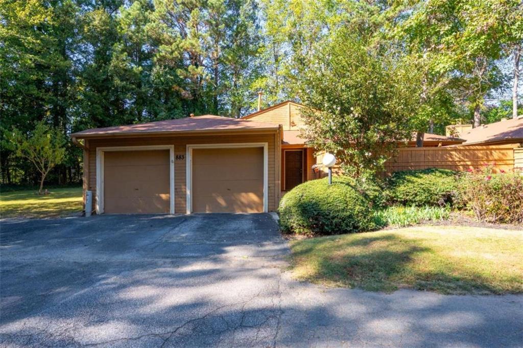 a view of a house with a yard and garage