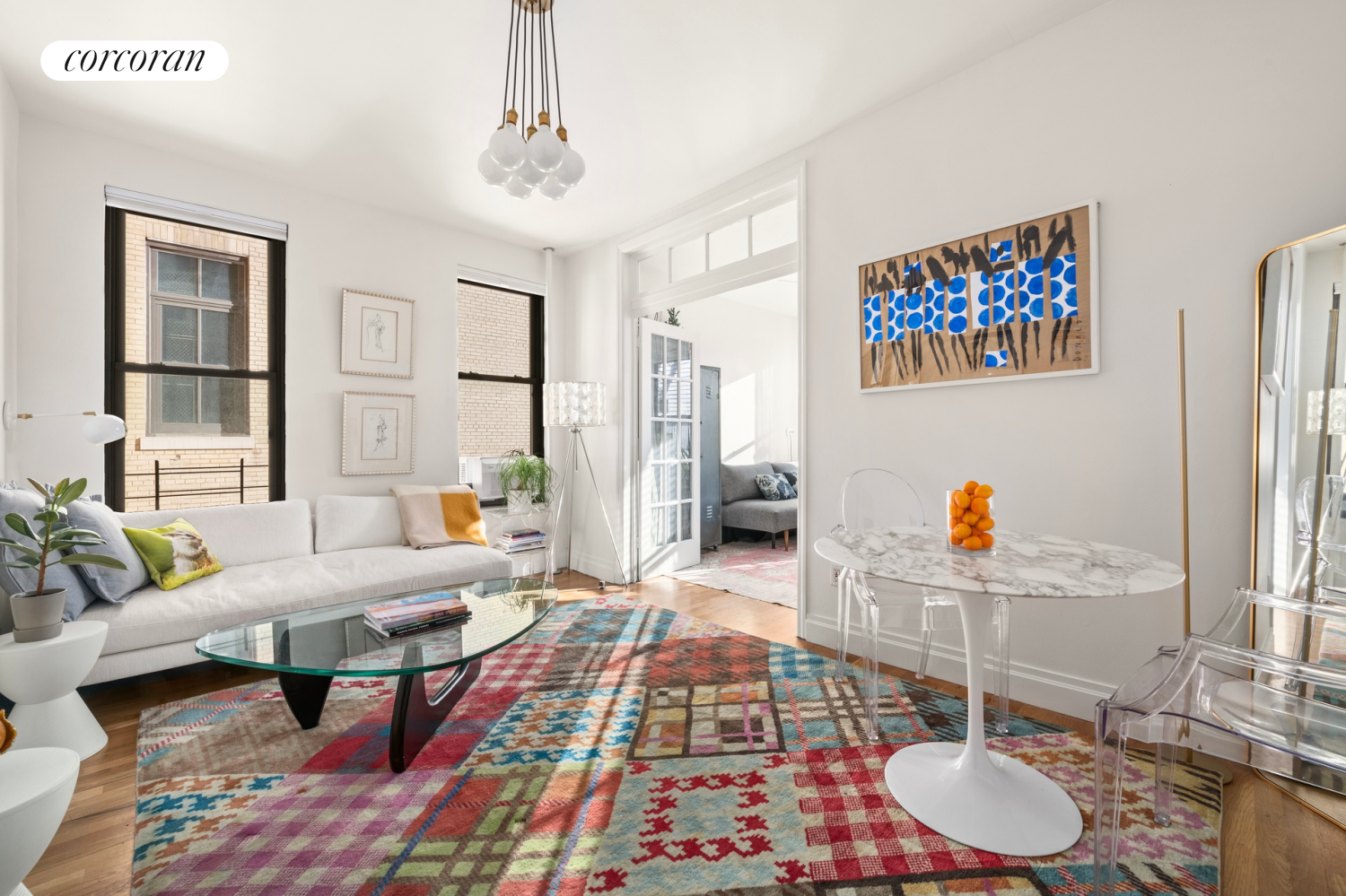 a living room with furniture and wooden floor