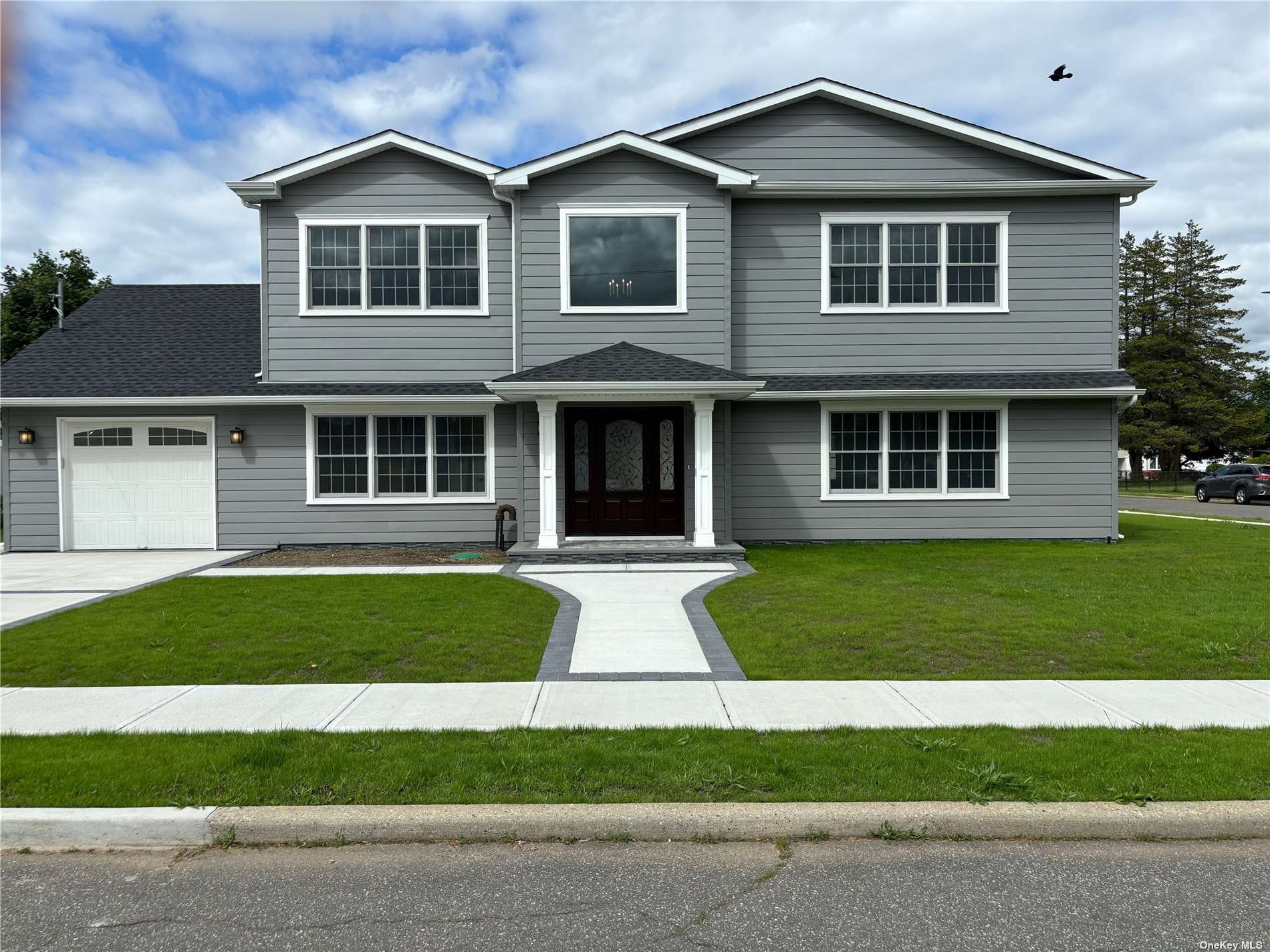 a front view of a house with a yard