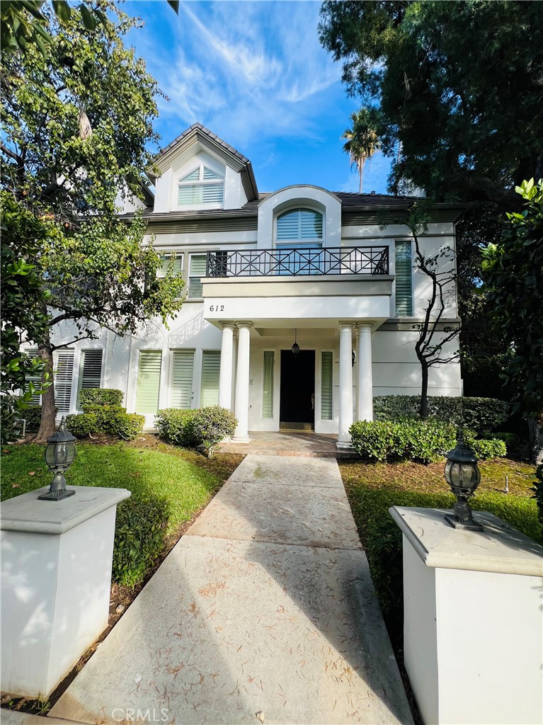 a front view of a residential houses with yard and green space