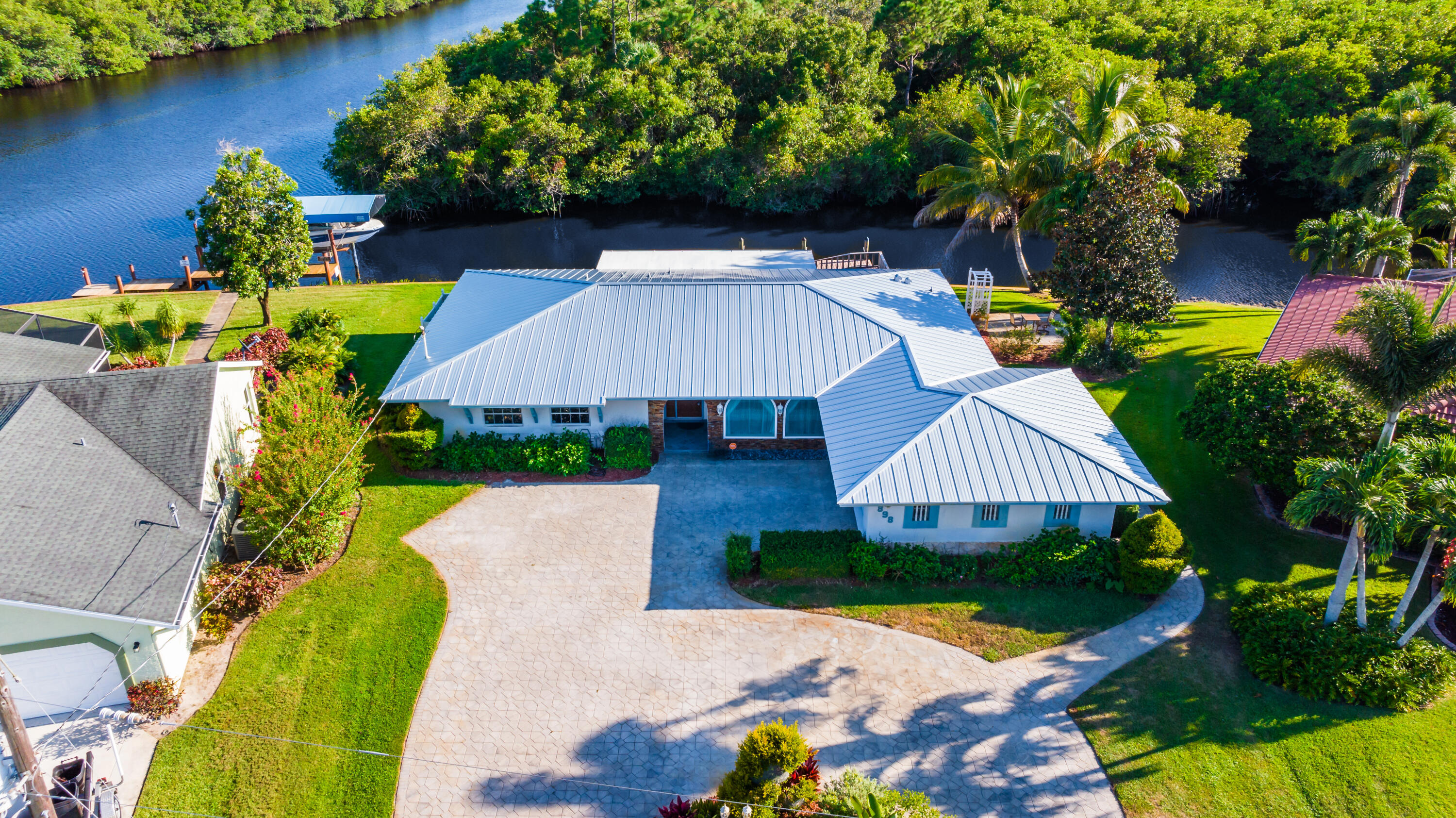 an aerial view of a house with swimming pool and outdoor seating