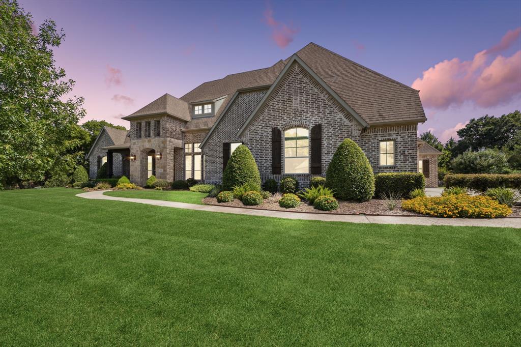 a front view of a house with a garden and plants