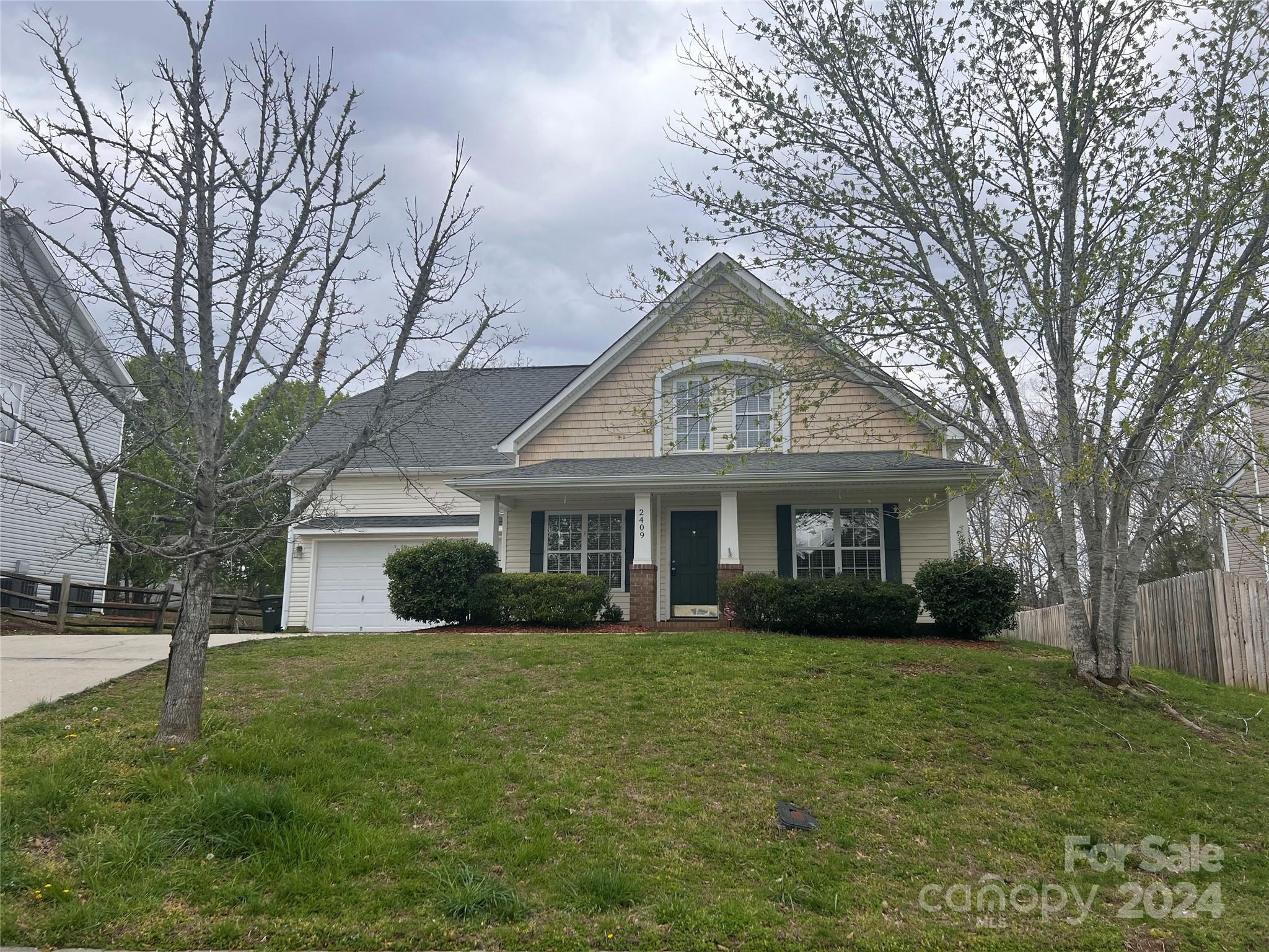 a front view of house with yard and green space