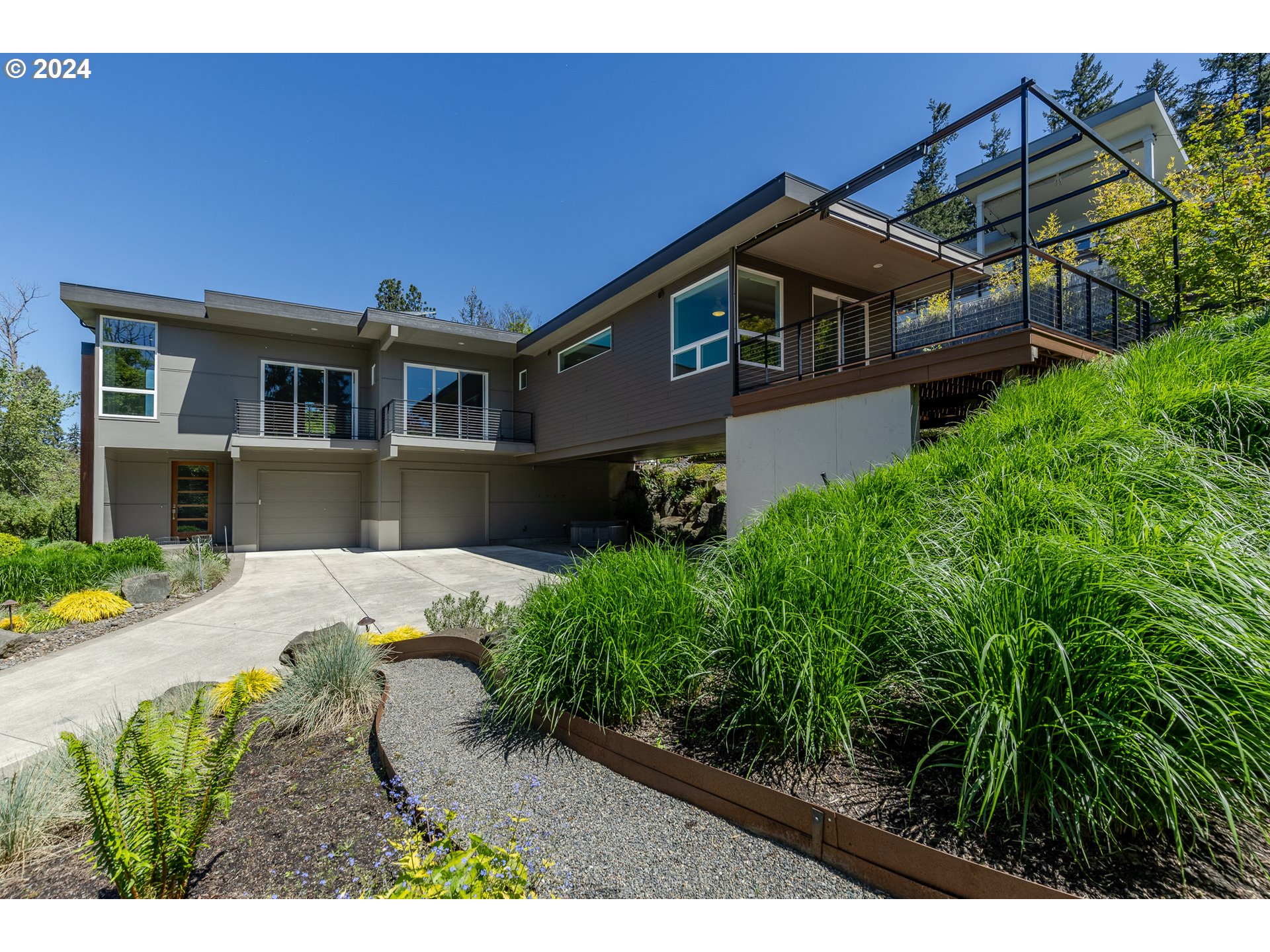 a front view of a house with a garden