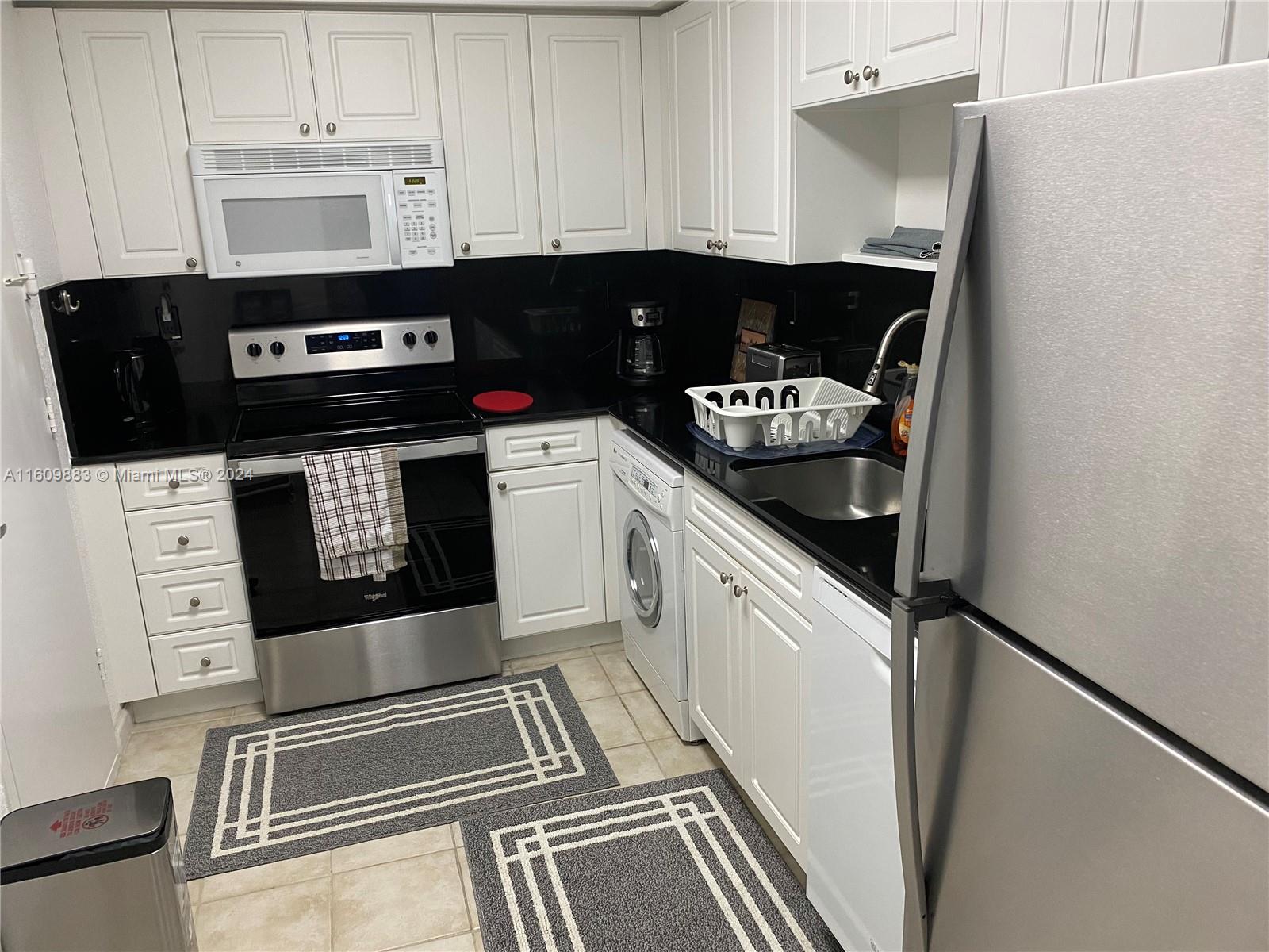 a kitchen with a stove and white cabinets