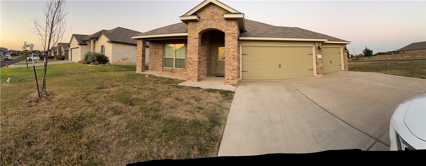 a front view of a house with garden