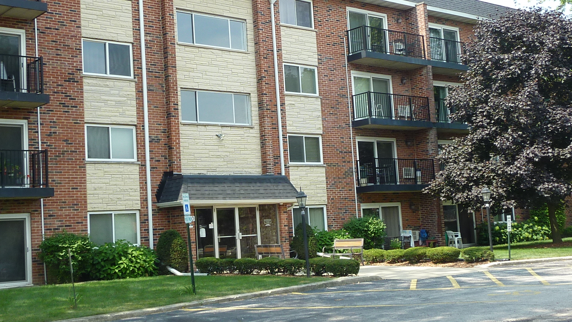 a view of a brick building next to a yard