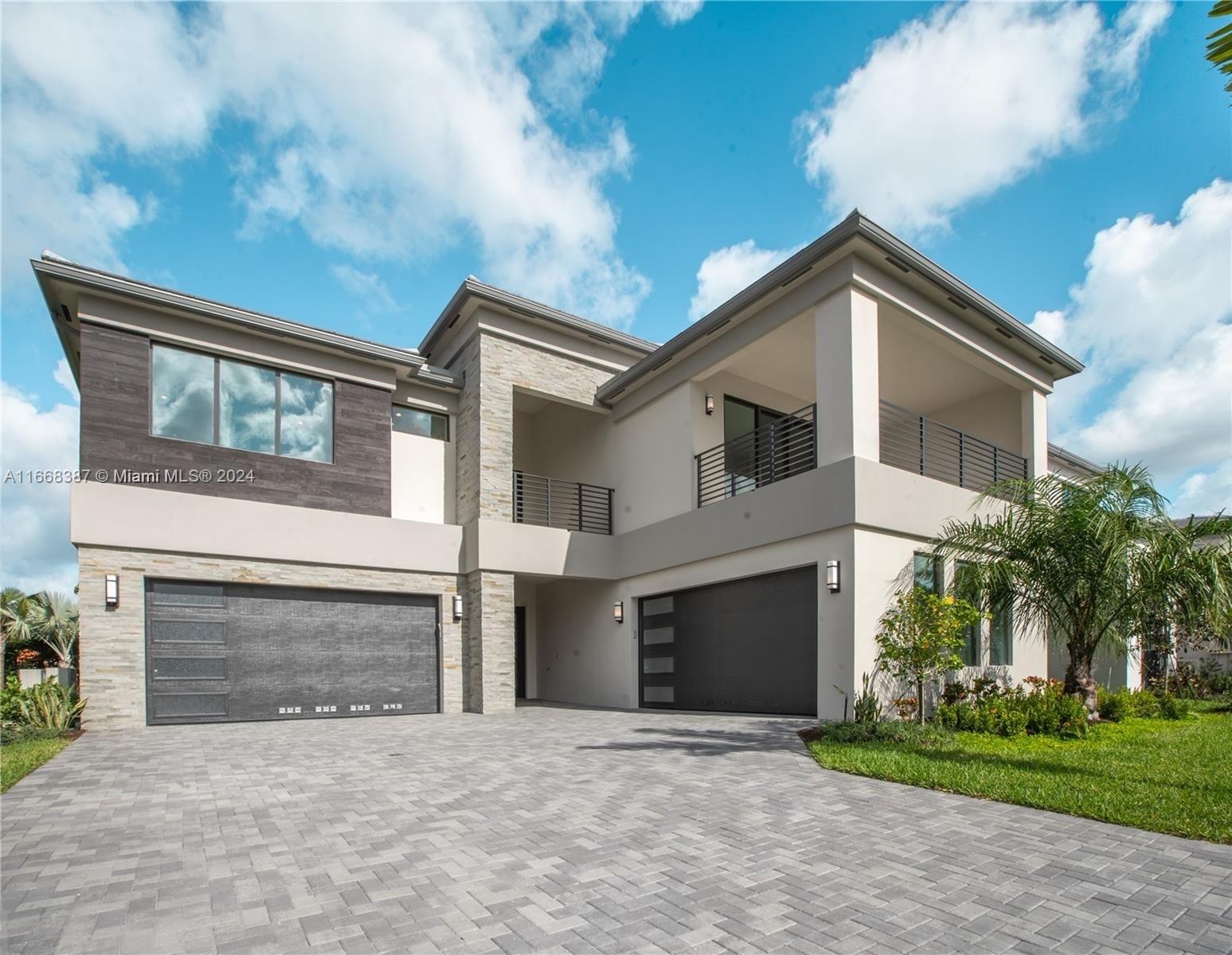 a front view of a house with yard and garage