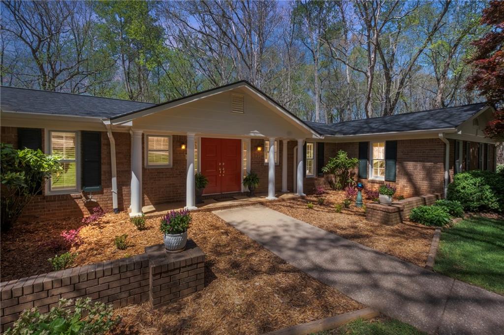 a view of a house with yard and sitting area