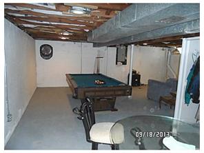 a living room with chairs and a table with wooden floor