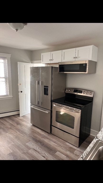 a kitchen with a stove a microwave and a refrigerator