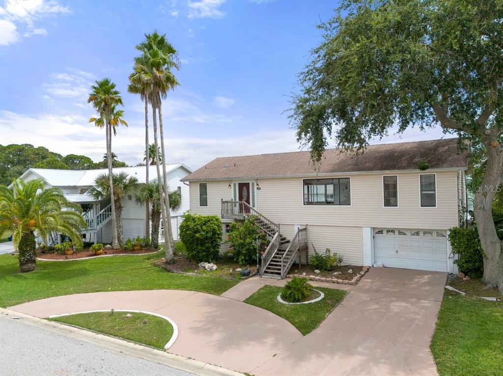 a front view of a house with a garden and yard