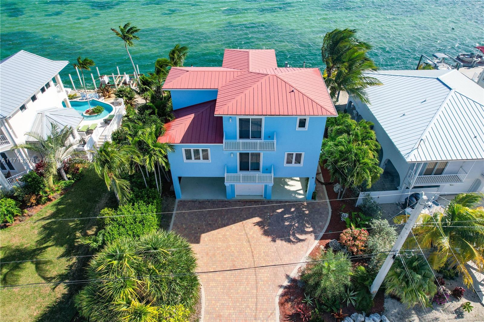 a aerial view of a house with yard and outdoor seating