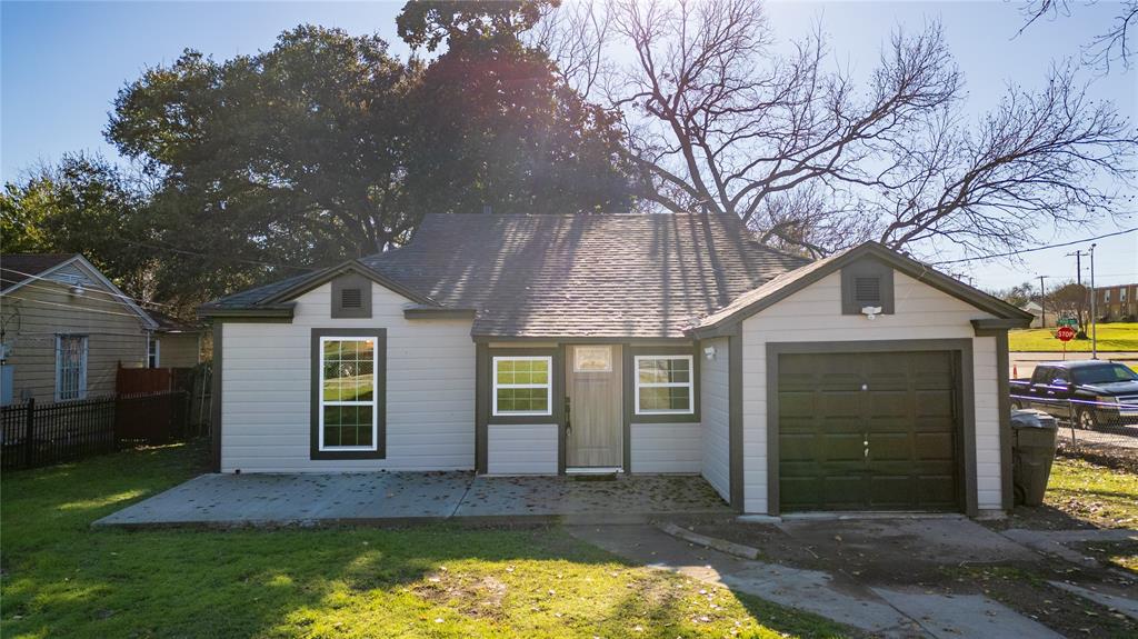 a front view of a house with yard and garage