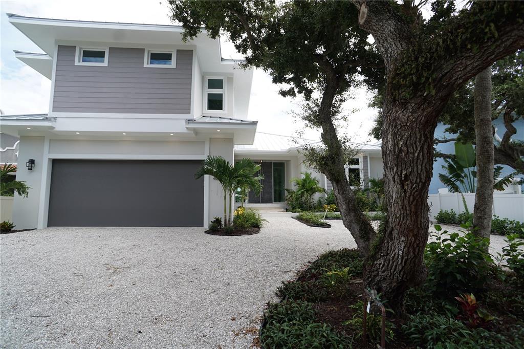 a front view of a house with a yard and a garage