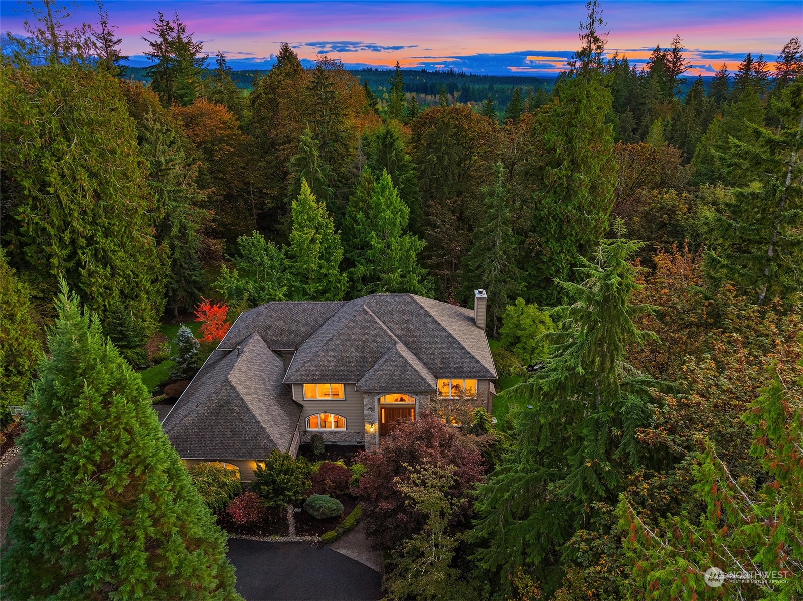 an aerial view of a house with green field