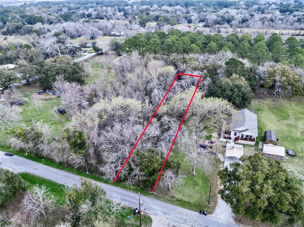 an aerial view of a house with a yard and lake