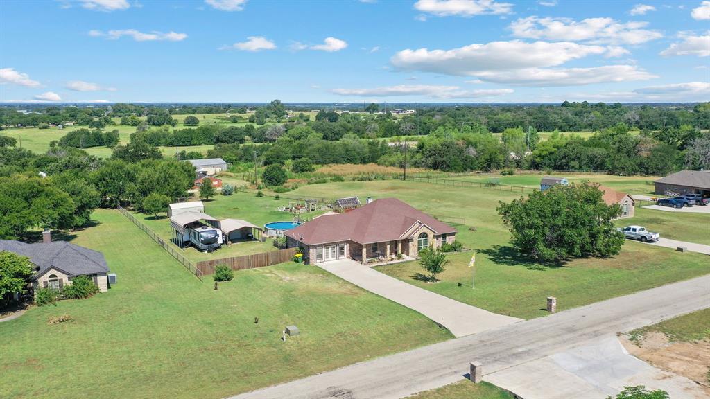 an aerial view of a house with garden space and street view