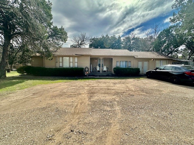 a front view of a house with a yard and trees